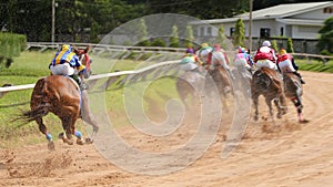 A racehorse and jockey in a horse race photo