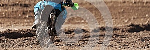 Racer child on motorcycle participates in motocross race