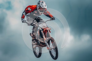 Racer jumping on a cross motorcycle against the cloudy thunder sky. Teenager in bright uniform and protective helmet