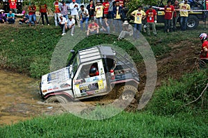 Racer offroad at terrain racing car competition