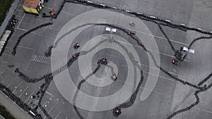 Racers traning or competing on the karting track in protective uniform and helmet, aerial view. Media. Kart driving