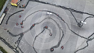 Racers traning or competing on the karting track in protective uniform and helmet, aerial view. Media. Kart driving