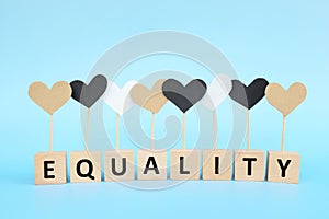 Racial equality, inclusion, love and cultural diversity concept. Brown, black and white color heart shape icon in blue