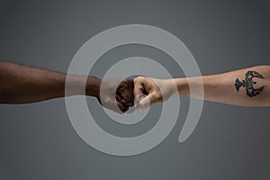 Racial tolerance. Respect social unity. African and caucasian hands gesturing isolated on gray studio background