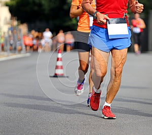 Racing and athletes in sportswear race on the streets