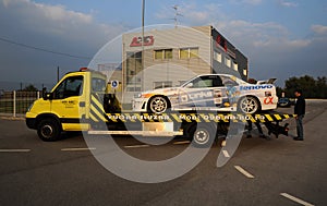 Racing car being transported on a truck in sunset
