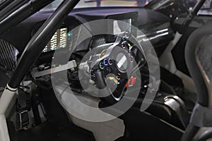 Racing car cockpit with electric steering wheel