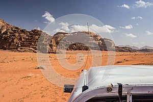 Racing car in desert landscape scenic environment extreme life style concept picture in Wadi Rum Middle East Jordanian heritage