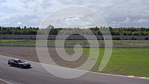 Racing car driving on speed rack. Aerial side view japanese car riding on track