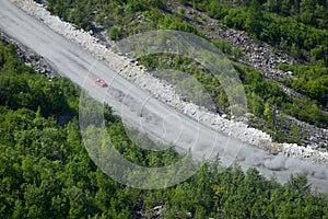 A racing car is moving on a mountain road