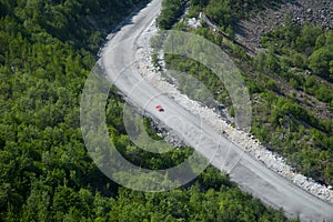 A racing car is moving on a mountain road