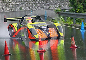 Racing car Radical SR4 sport prototype, during an uphill speed race in the rain