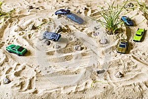 Racing cars on the sand compete in the game.