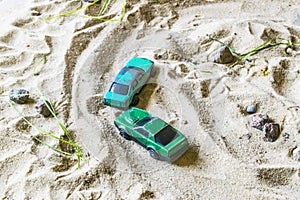 Racing cars on the sand compete in a game of survival.