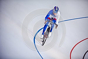 Racing cyclist on velodrome outdoor. photo