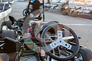 Racing karts waiting for the race on the pit lane of the kartodrome. Cockpit view. Family and friends pastime