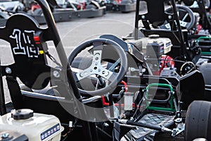 Racing karts waiting for the race on the pit lane of the kartodrome. Family and friends pastime