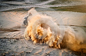 Racing powerful quad bike on the difficult sand in the summer