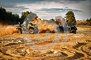 Racing powerful quad bike on the difficult sand in the summer