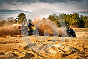 Racing powerful quad bike on the difficult sand in the summer