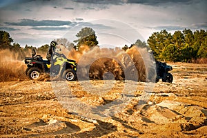 Racing powerful quad bike on the difficult sand in the summer