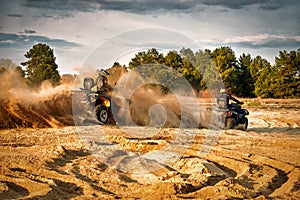 Racing powerful quad bike on the difficult sand in the summer