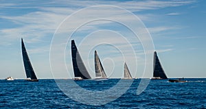 Racing sailing yachts with black sails