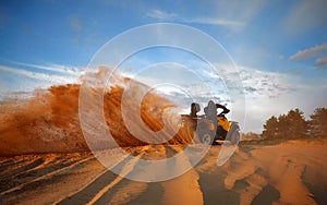 Racing in the sand on a four-wheel drive quad