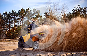 Racing in the sand on a four-wheel drive quad