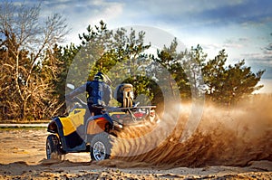 Racing in the sand on a four-wheel drive quad