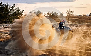 Racing in the sand on a four-wheel drive quad