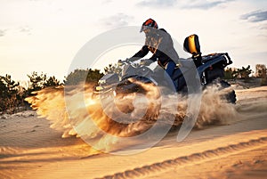 Racing in the sand on a four-wheel drive quad