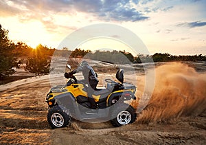 Racing in the sand on a four-wheel drive quad
