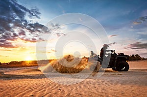 Racing in the sand on a four-wheel drive quad