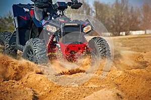 Racing in the sand on a four-wheel drive quad