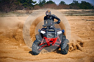 Racing in the sand on a four-wheel drive quad