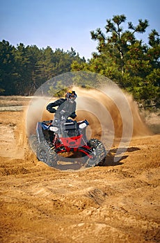 Racing in the sand on a four-wheel drive quad