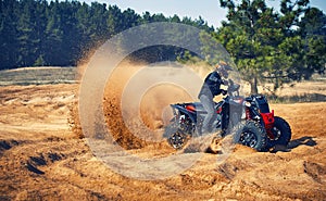 Racing in the sand on a four-wheel drive quad