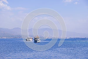 Racing yacht in the sea on blue sky background. Peaceful seascape. Beautiful blue sky over calm sea.