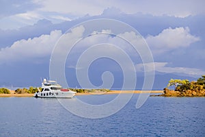 Racing yacht in the sea on blue sky background. Peaceful seascape. Beautiful blue sky over calm sea