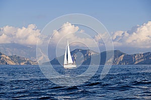 Racing yacht in the sea on blue sky background. Peaceful seascape. Travel concept, travelling.