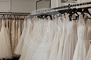 a rack of aline wedding dresses in a clean store setting