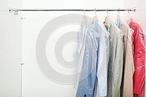 Rack with clean clothes after dry-cleaning