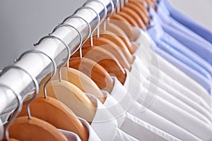 Rack with clean clothes on hangers