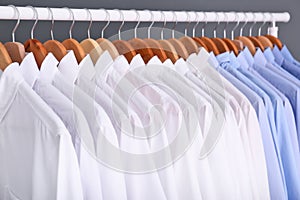 Rack with clean clothes on hangers