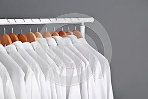 Rack with clean clothes on hangers