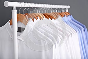 Rack with clean clothes on hangers