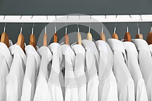 Rack with clean clothes on hangers