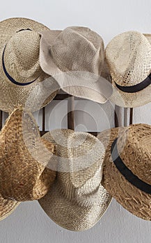 Rack cluttered with hats made from vegetable fibers