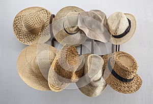 Rack cluttered with hats made from vegetable fibers